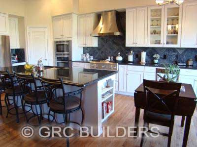 Updated kitchen with white cabinetry and an island.